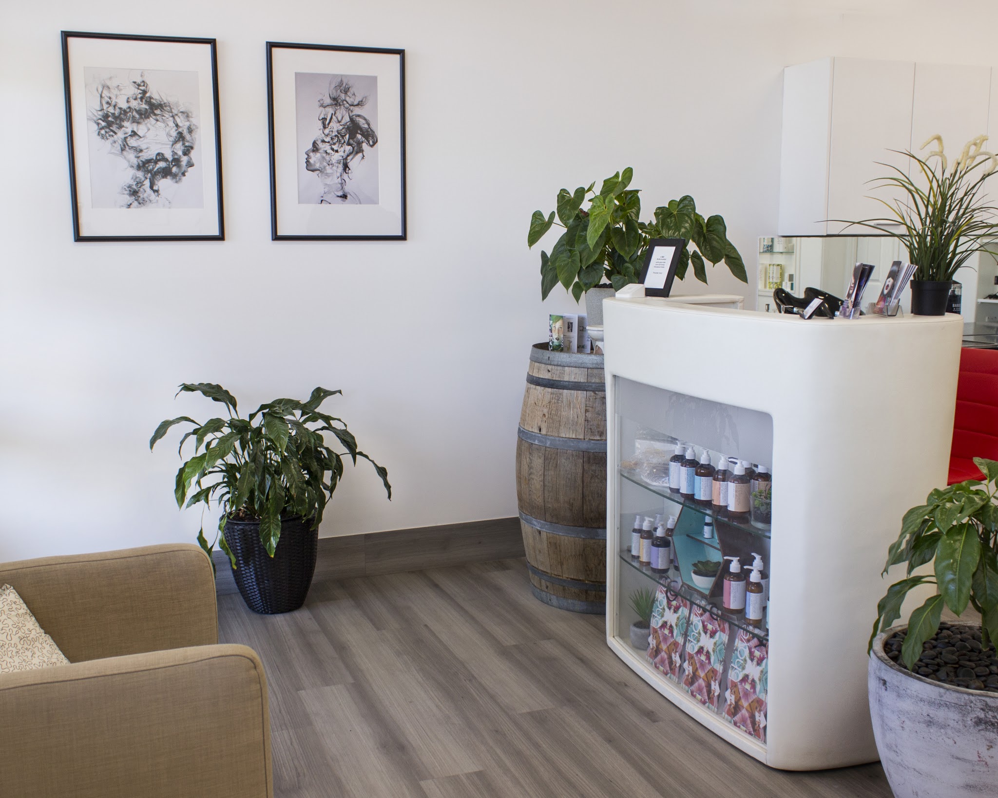 Reception desk with a whiskey barrel side table and framed line drawings